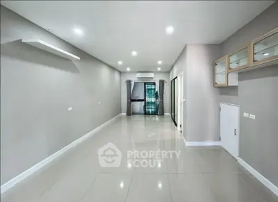 Spacious modern living room with sleek tile flooring and built-in storage
