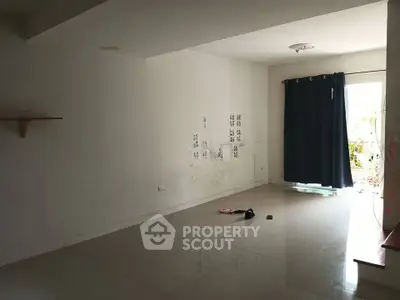 Spacious empty room with tiled flooring and natural light