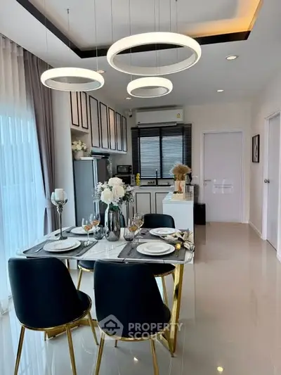Modern dining area with elegant table setting and stylish kitchen in open layout