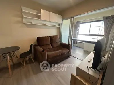 Cozy living room with brown sofa, modern shelving, and large window for natural light.
