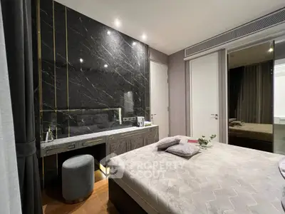 Luxurious bedroom with elegant marble accent wall and plush bedding