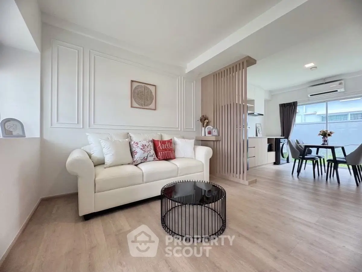 Modern open-concept living room with stylish decor and natural light.