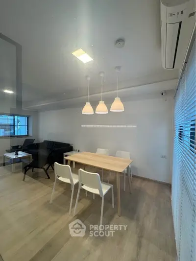 Modern dining area with sleek furniture and ambient lighting in a stylish apartment.