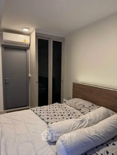 Cozy bedroom with modern design, featuring a comfortable bed and sleek wardrobe, perfect for restful nights.