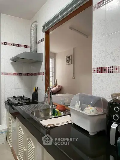 Charming kitchen with modern appliances and open layout, perfect for culinary enthusiasts.