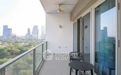 Spacious balcony with city skyline view and modern outdoor seating.