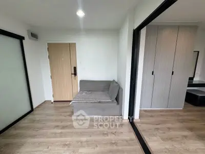 Modern apartment interior with wooden flooring and sleek sliding doors.
