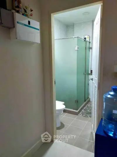 Compact bathroom with glass shower enclosure and modern fixtures