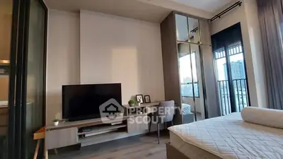 Modern bedroom with balcony view, stylish furniture, and natural light.