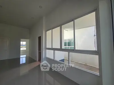 Spacious modern interior with large windows and glossy floors