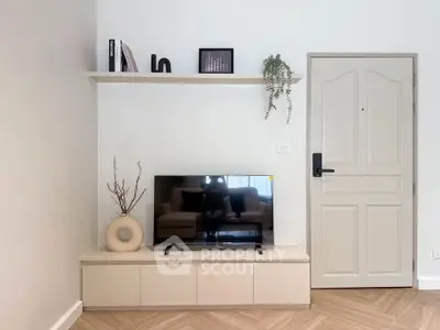 Modern living room with stylish TV stand and decorative shelf, featuring minimalist design and neutral tones.
