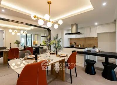 Luxurious modern dining area with elegant lighting and open kitchen layout