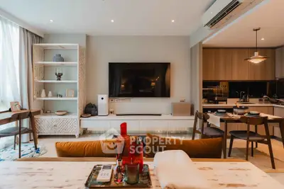 Modern open-plan living room with stylish decor and integrated kitchen area