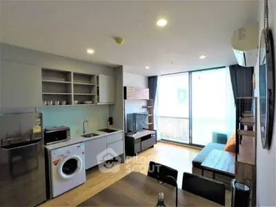 Modern living room with open kitchen and balcony in a stylish apartment