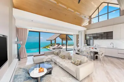 Luxurious open-plan living room with stunning ocean view and modern kitchen.