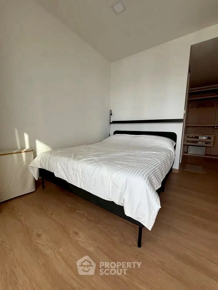 Modern bedroom with minimalist design and wooden flooring