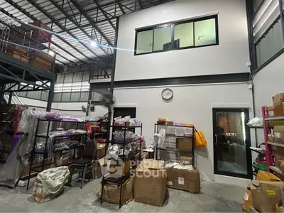 Spacious warehouse interior with organized shelving and storage boxes
