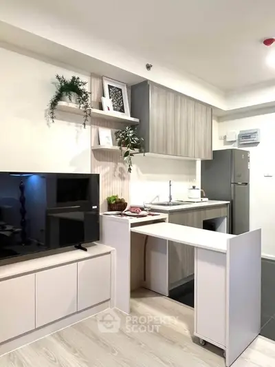 Modern kitchen with sleek cabinetry and integrated appliances in a stylish apartment.