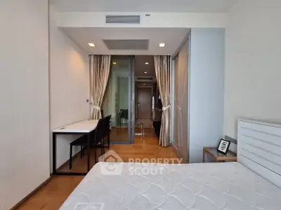 Modern bedroom with study area and glass partition in a stylish apartment