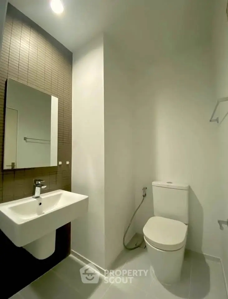 Modern minimalist bathroom with sleek fixtures and neutral tones