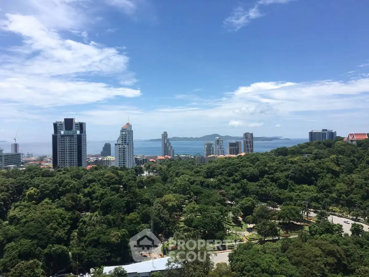 Stunning cityscape view with lush greenery and ocean backdrop, perfect for urban living enthusiasts.