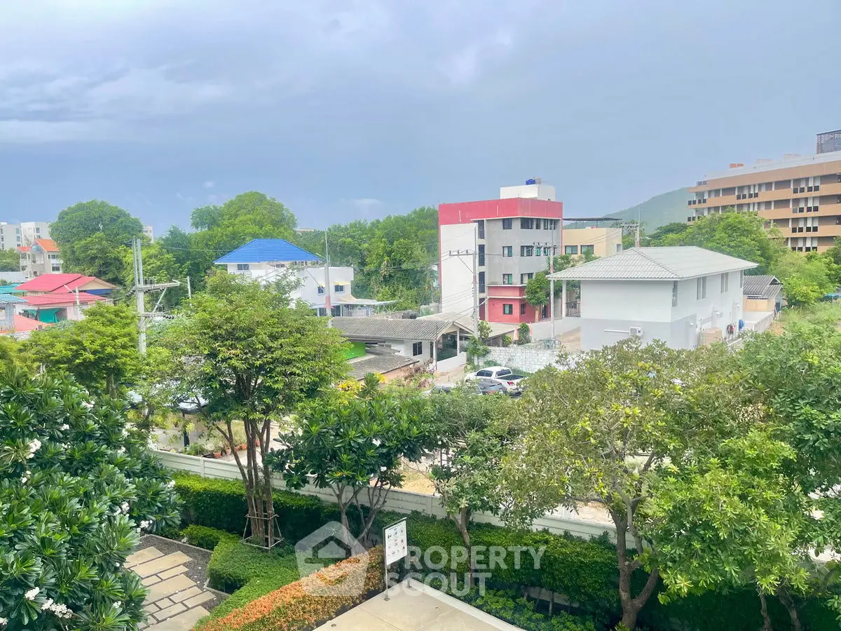 Scenic view of residential area with lush greenery and modern buildings.