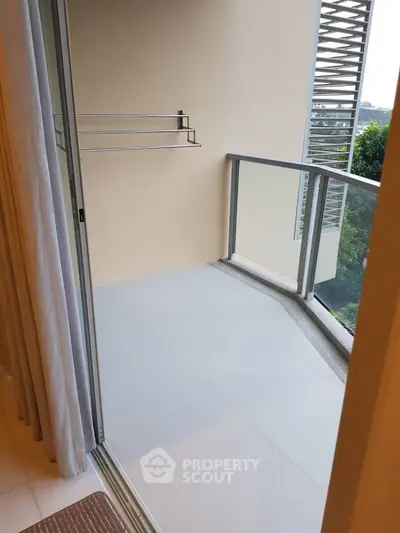 Spacious balcony with modern railing and serene view