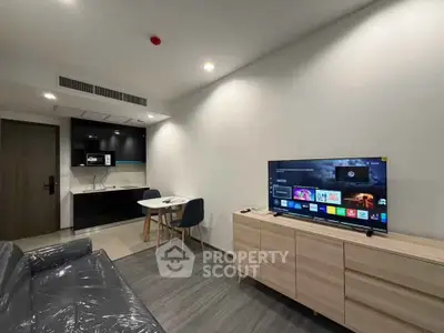 Modern living room with sleek furniture and smart TV in a stylish apartment.