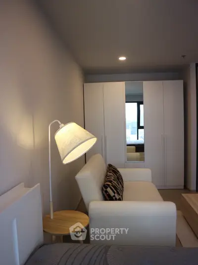 Modern living room with cozy white sofa and stylish lamp