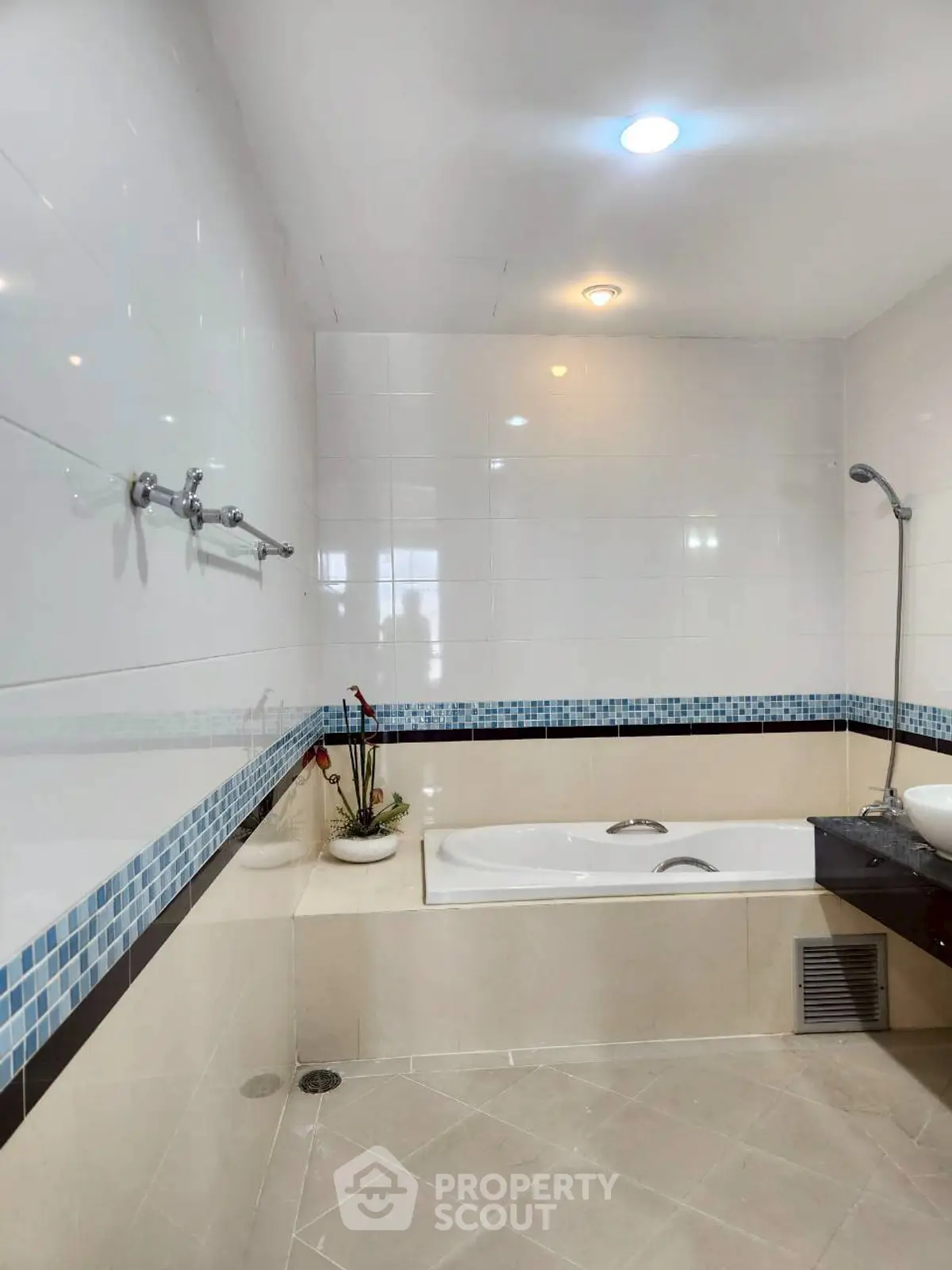 Spacious bathroom with bathtub and modern fixtures in a stylish real estate property.
