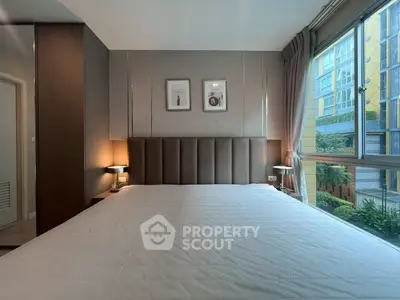 Modern bedroom with large window and stylish decor in urban apartment