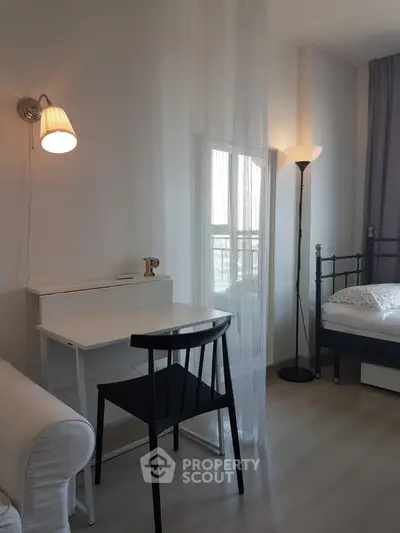 Cozy bedroom with modern desk and stylish lighting, perfect for a serene living space.
