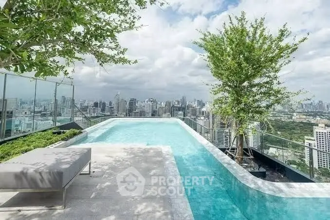 Stunning rooftop pool with panoramic city skyline views and lush greenery.