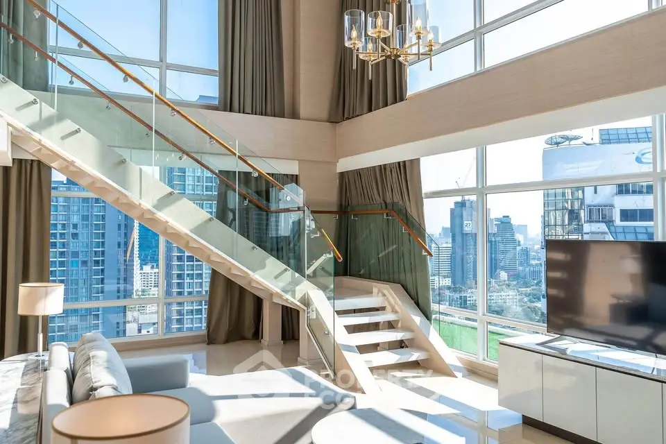 Luxurious modern living room with glass staircase and panoramic city views