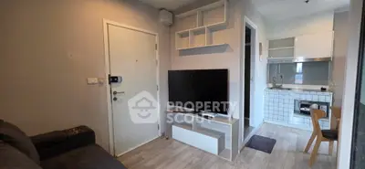 Modern apartment interior with cozy living room and compact kitchen layout.