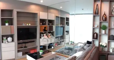 Luxurious modern living room with stylish shelving and plush seating in a high-rise apartment.