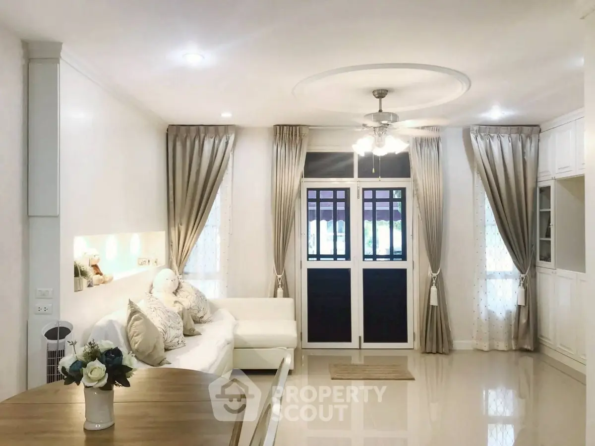 Elegant living room with plush sofa and stylish curtains, perfect for relaxation.
