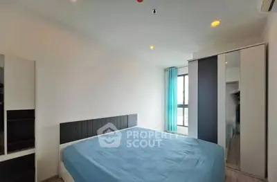 Modern bedroom with large bed and mirrored wardrobe in bright apartment