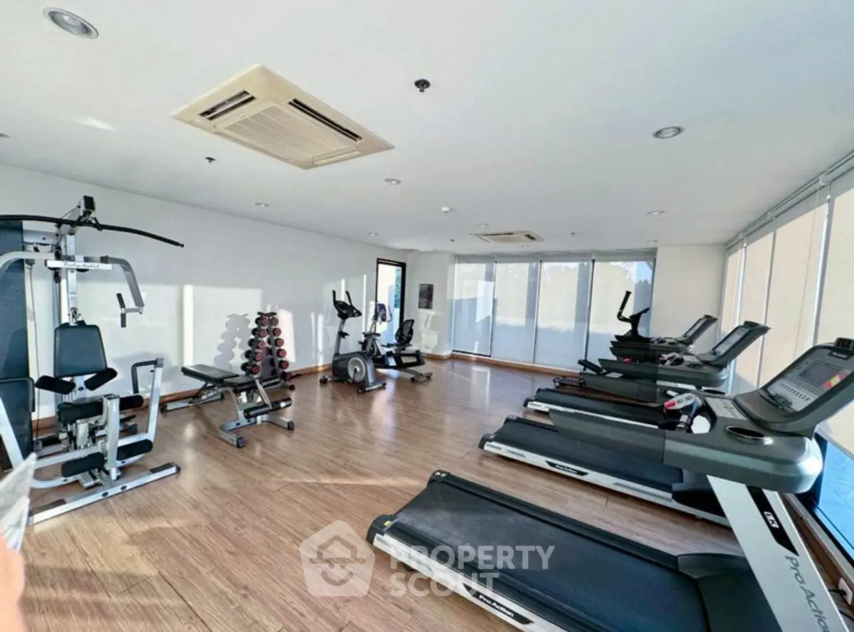 Spacious gym with modern equipment and natural light