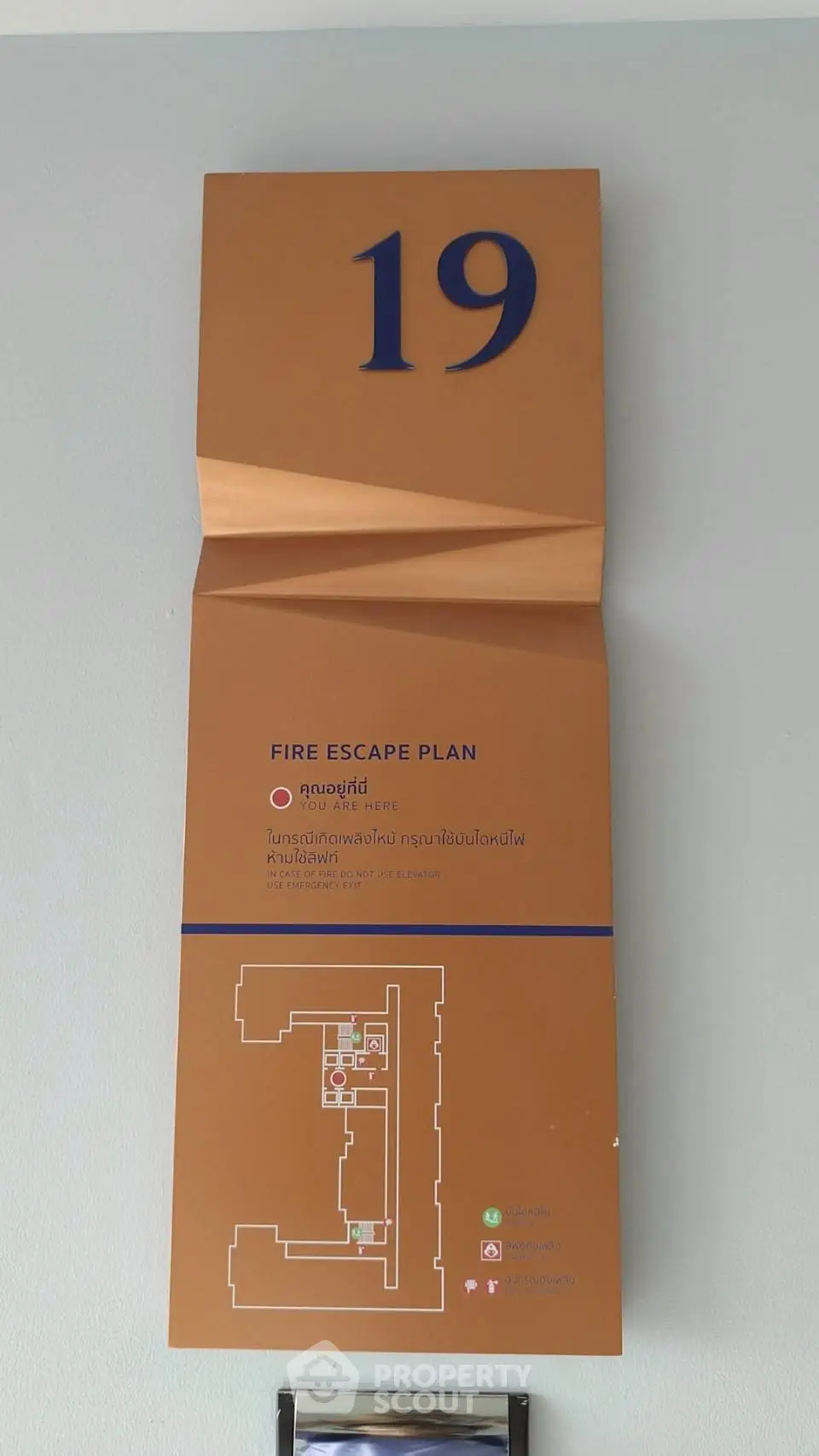 Fire escape plan on wall with floor layout for safety in building