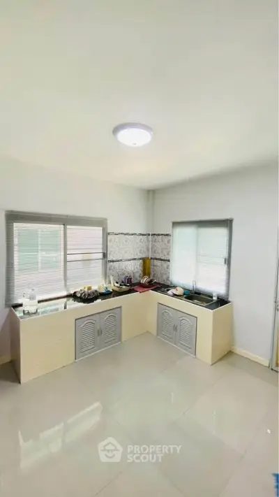 Spacious kitchen with modern closed layout and ample natural light.