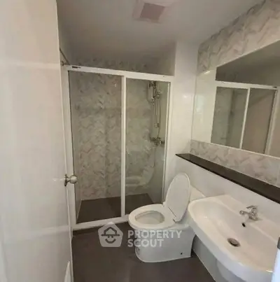 Modern bathroom with sleek shower and elegant fixtures in a contemporary home.