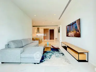 Spacious modern living room with elegant decor and open kitchen layout in luxury apartment.