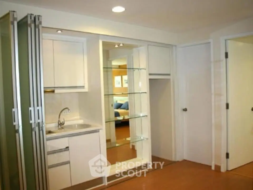 Modern compact kitchen with sleek cabinetry and open shelving