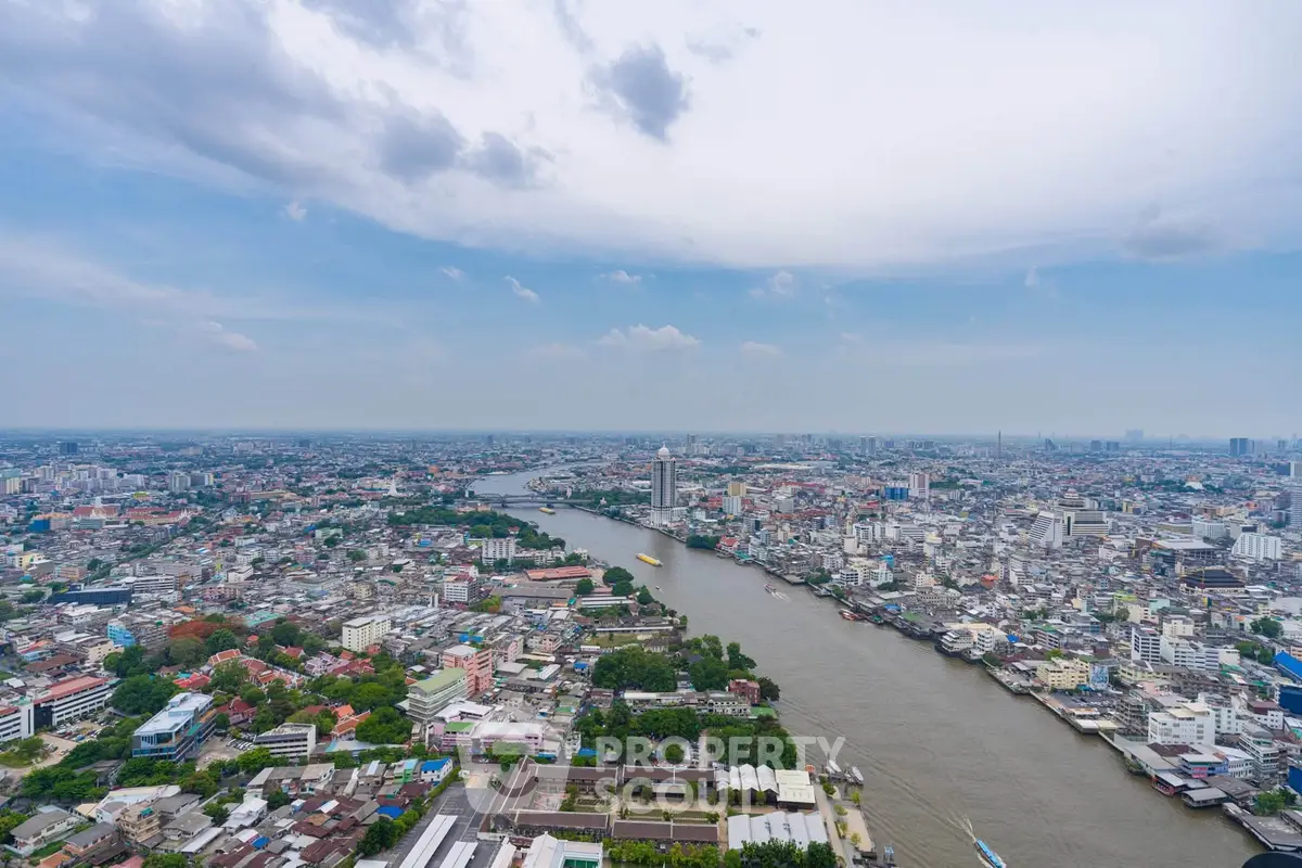 Stunning aerial view of a vibrant cityscape with a winding river and expansive skyline.