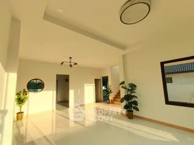 Spacious modern living room with elegant lighting and large windows