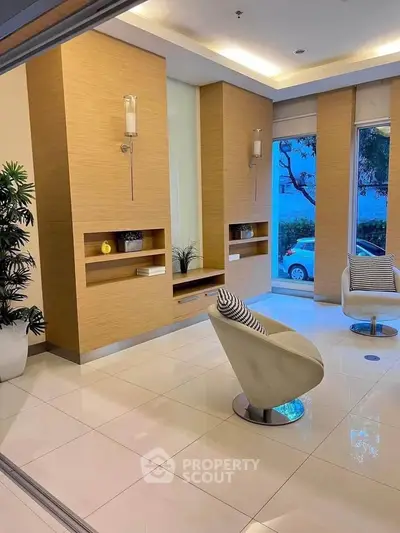 Modern living room with sleek design and large windows offering natural light.