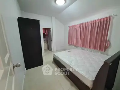 Cozy bedroom with pink curtains and a comfortable bed, perfect for restful nights.