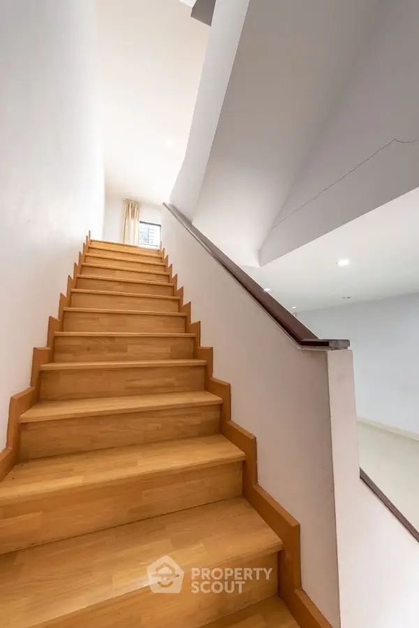 Modern wooden staircase with sleek design in a bright interior space