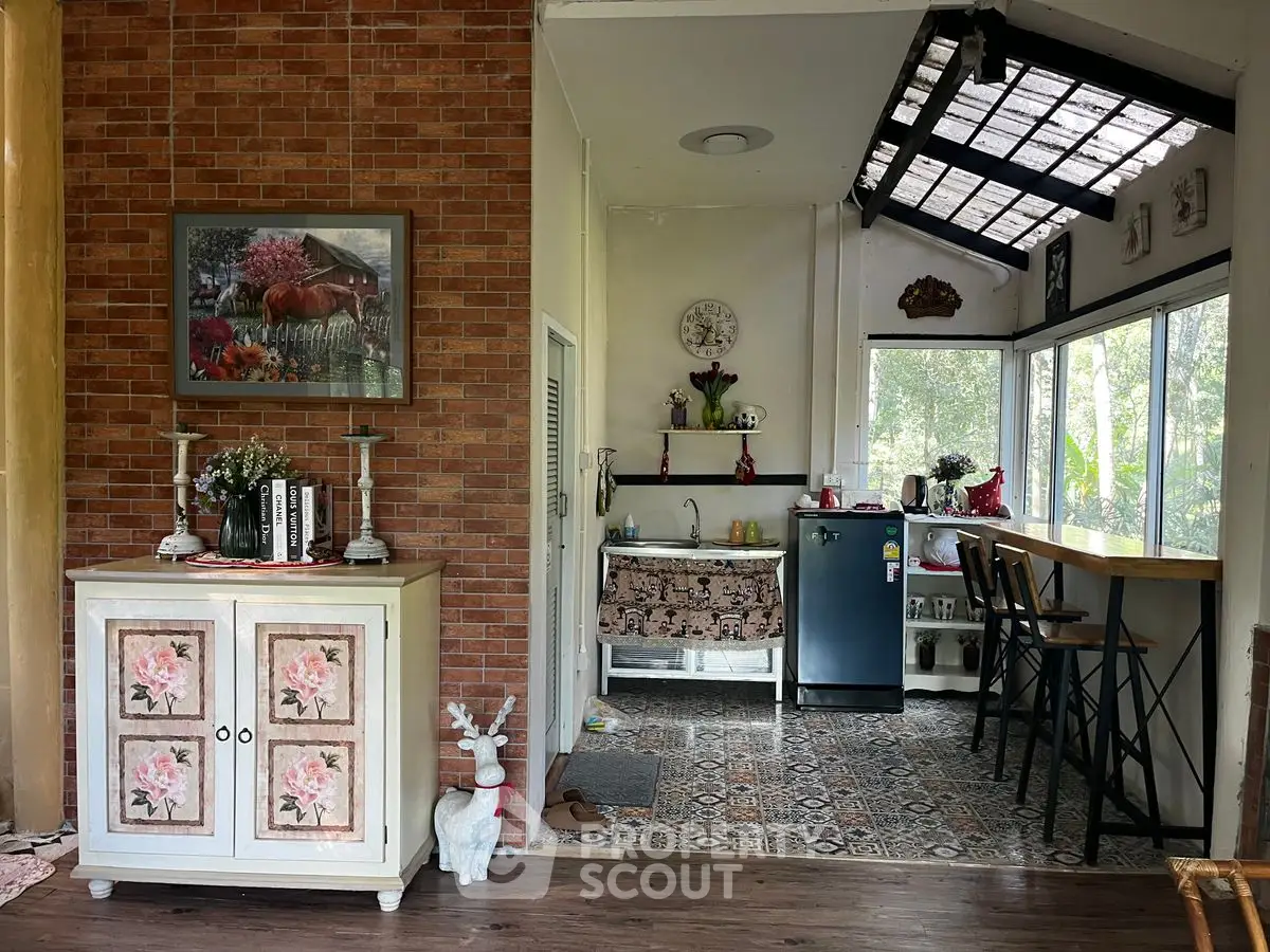 Charming rustic kitchen with open layout and natural light, featuring a cozy breakfast bar and vintage decor.